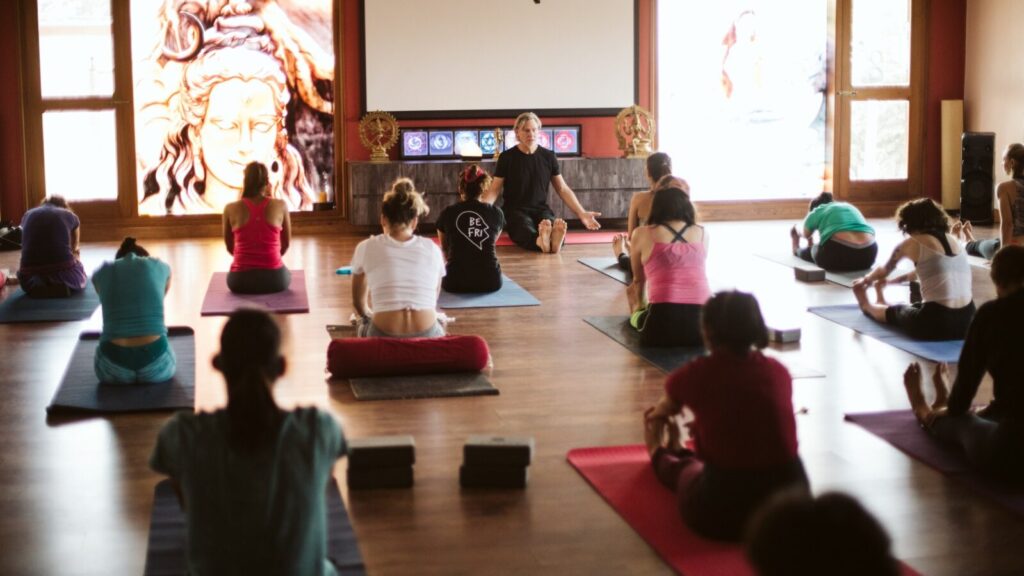 Yin yoga class at Nirvana Yoga Shala, Mysore, India, doing Caterpillar posture.